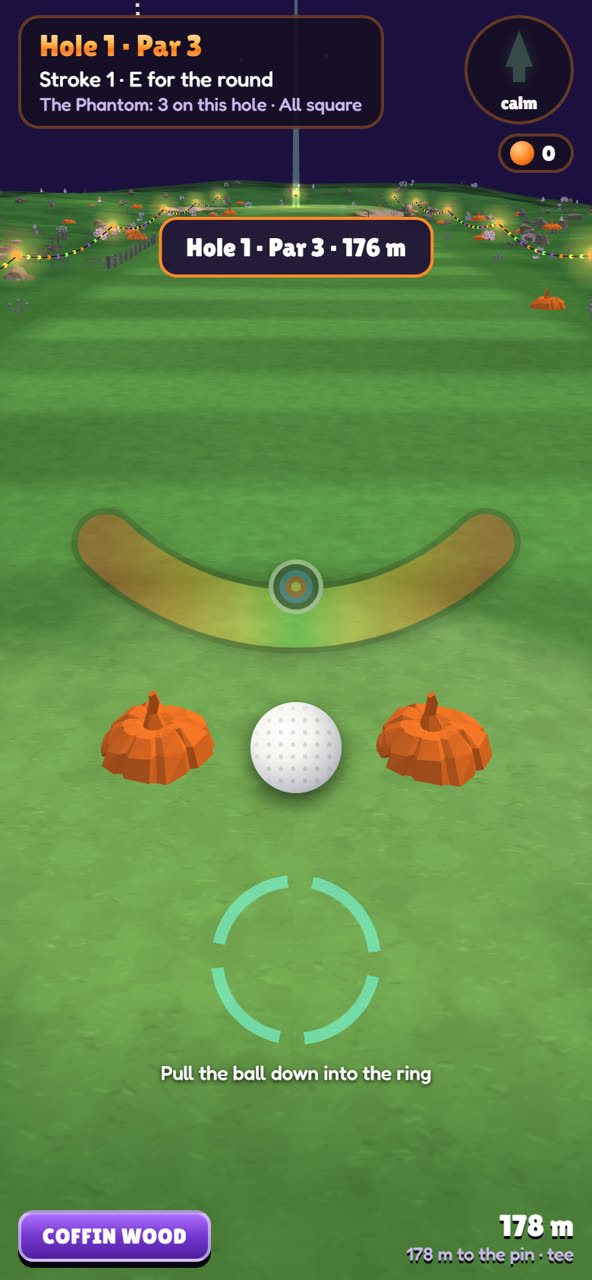 On the tee between two pumpkins, with fairground lights strung down the fairway