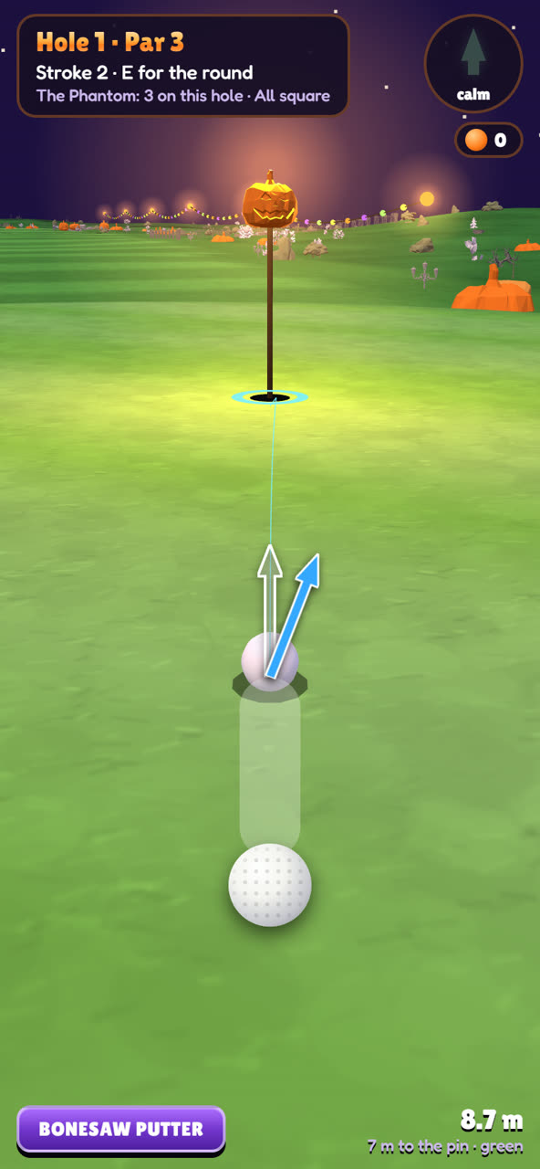 Lining up a putt to the carved pumpkin flag, the blue arrow sweeping round the aim line